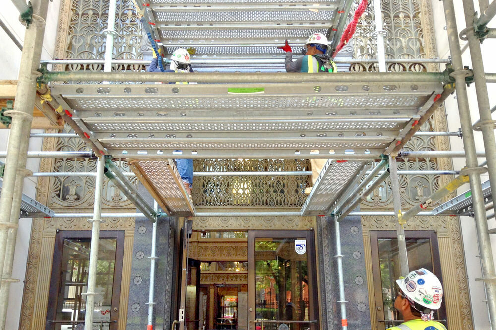 workers on scaffolding supporting Central Library Renovation