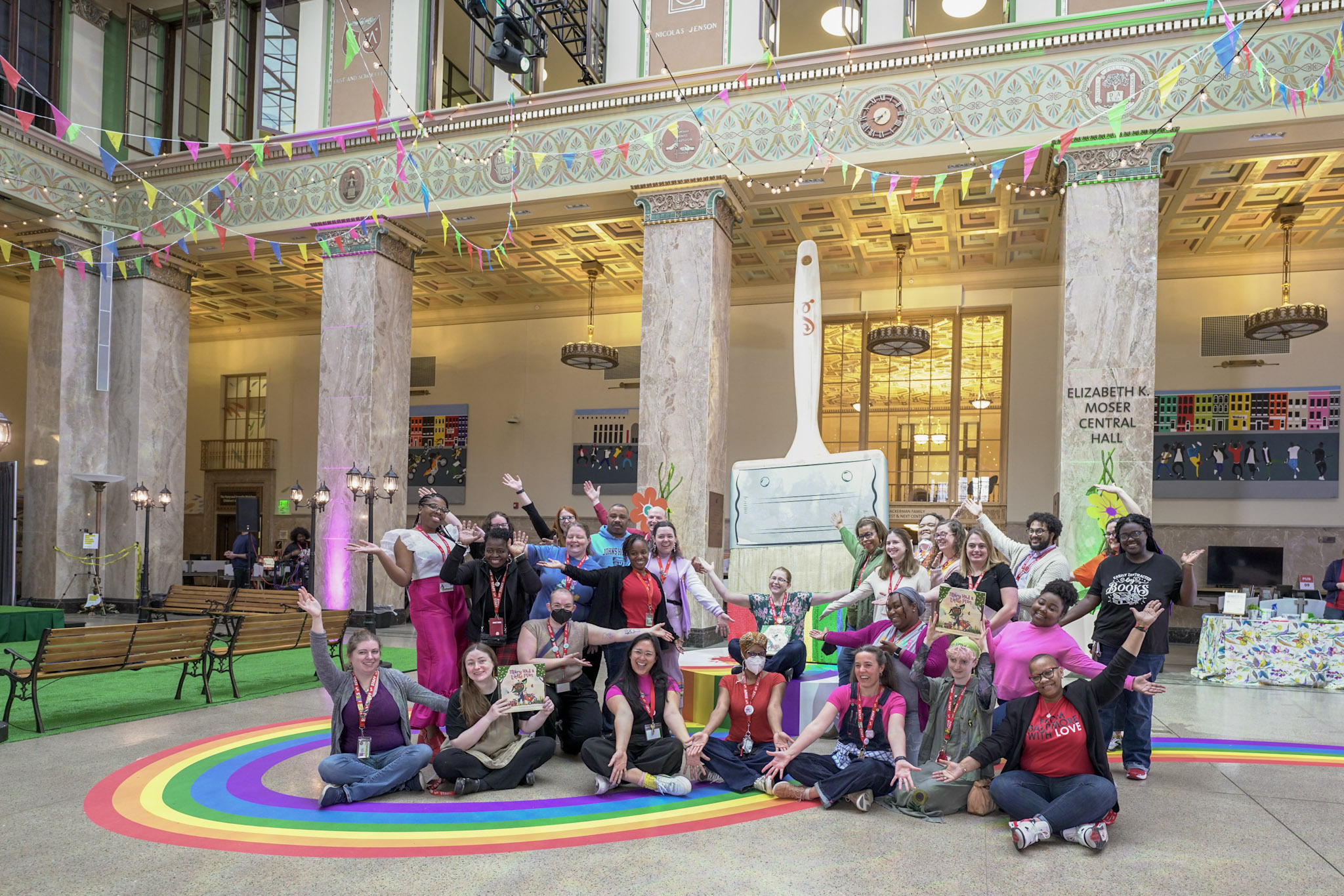 Staff in Central Hall with rainbow paintbrush for the Imagination Celebration