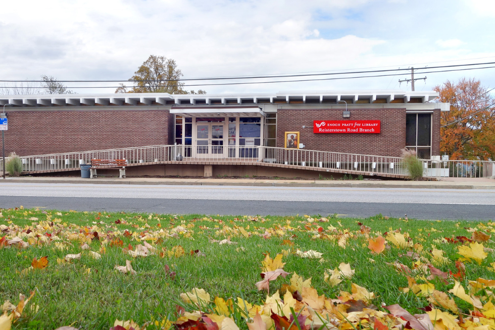 Exterior photo of the Reisterstown branch building, with a leafy lawn in the foreground.