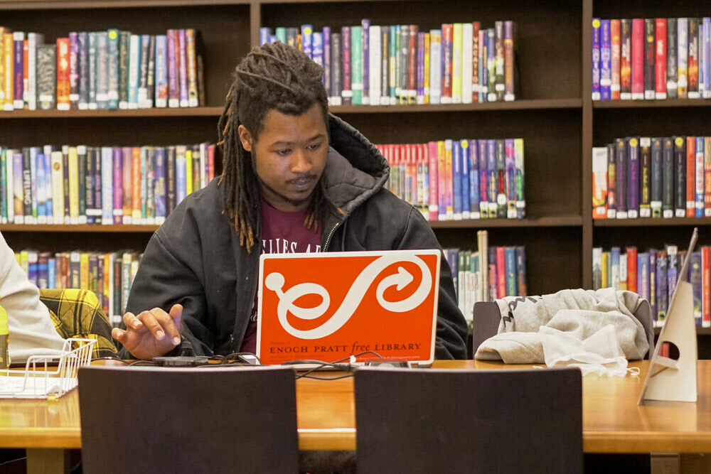 Pratt Library laptop user in the library