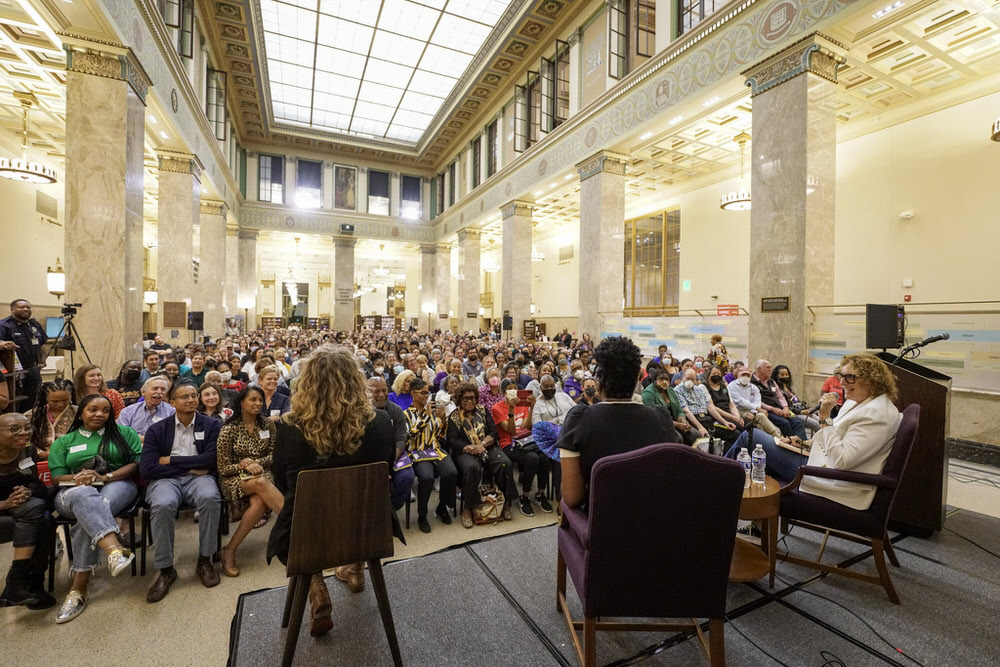 Central Hall audience and speakers onstage at Leslie Jonesebent