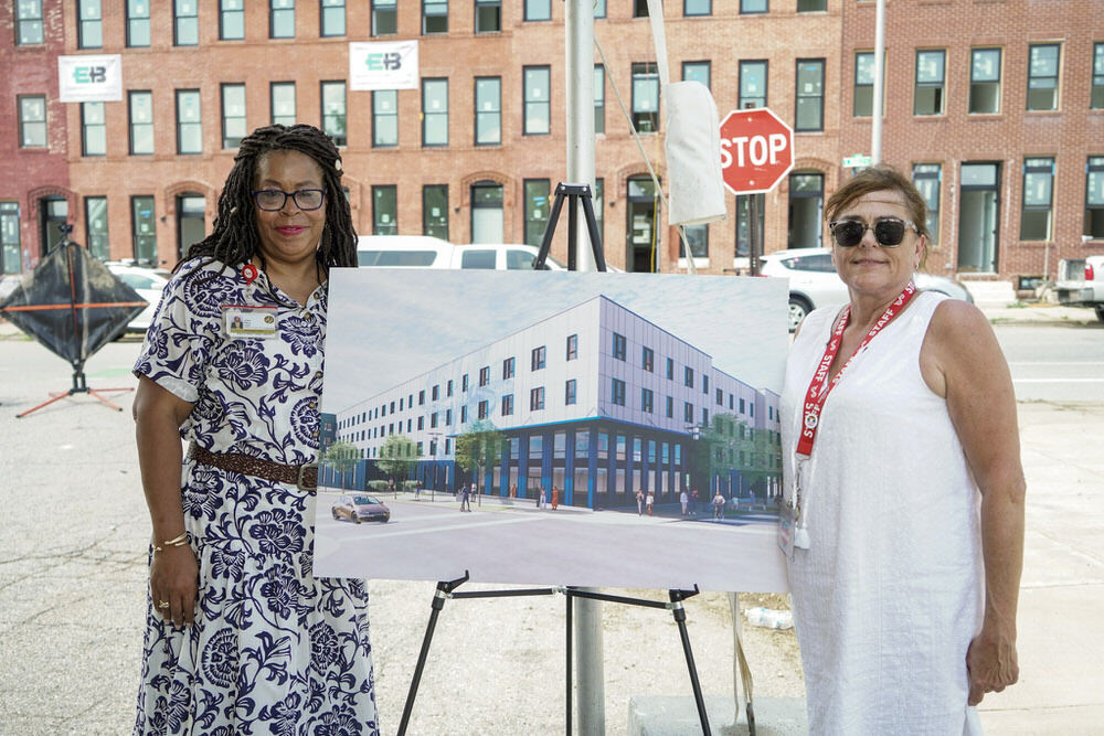 Johnston Square Branch rendering on site with Pratt Library staff members