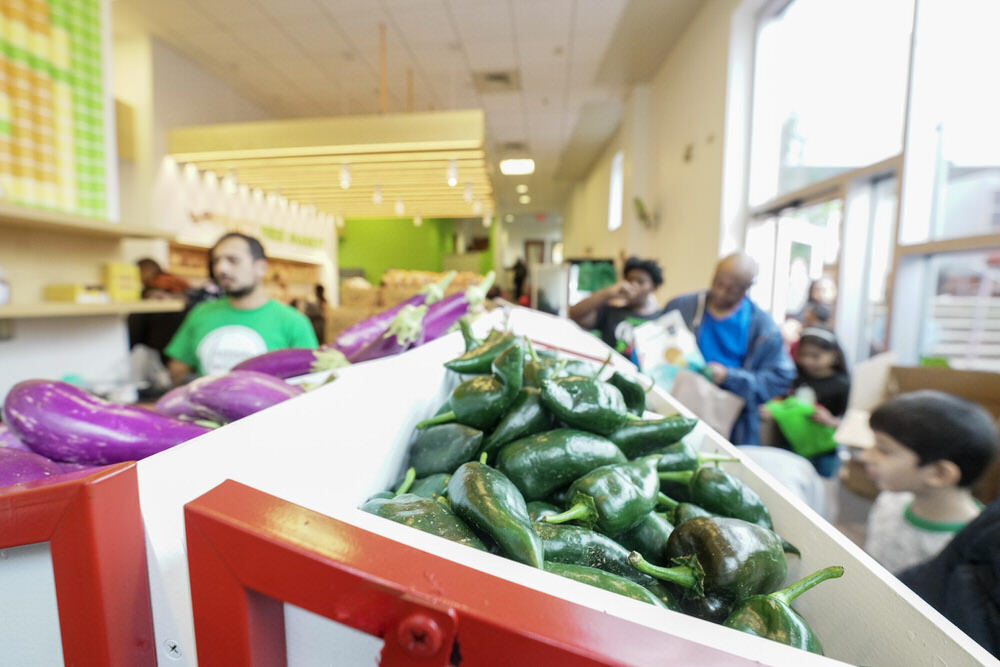 Pratt Free Market with peppers eggplants, pepper, and people