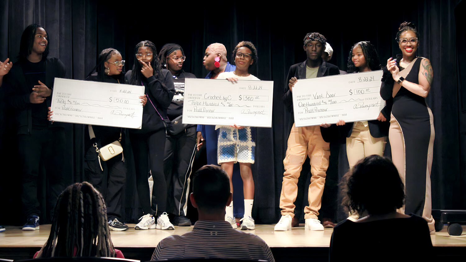 PRATTpreneur group on stage with oversized checks