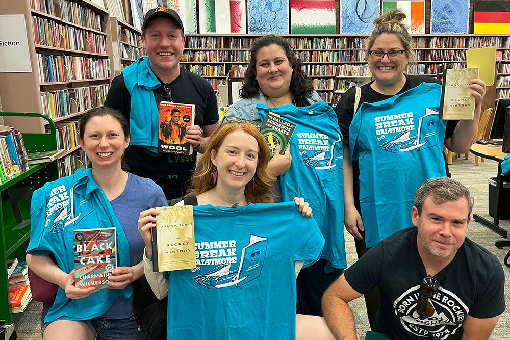 Summer Break Baltimore 2024 participants adults with tshirts and books