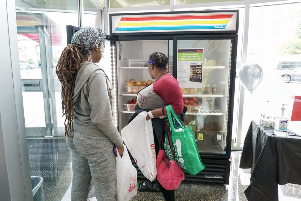 women shopping at the free food panty fridge