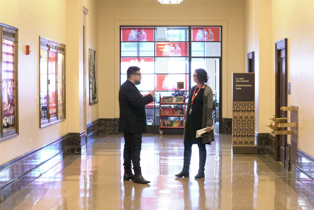 administrative partnerships - staff talking with the with artist in residence