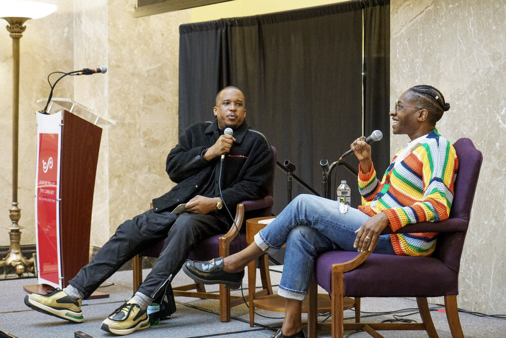 writers speaking on stage - D Watkins and Jaqueline Woodson