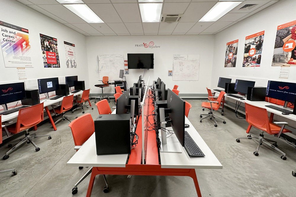 Open Works Lab - Pratt Anywhere room with computers, tables, chairs, posters